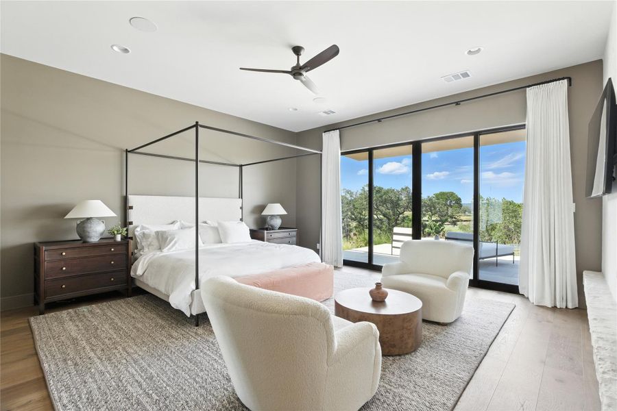 Bedroom featuring light wood-style floors, ceiling fan, and access to exterior