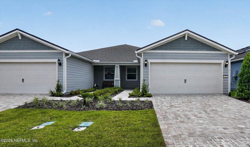 Front exterior of a new home in Del Webb Wildlight, Wildlight, FL, highlighting curb appeal (Image 1). Front exterior of a new home in Del Webb Wildlight, Wildlight, FL, highlighting curb appeal (Image 1).