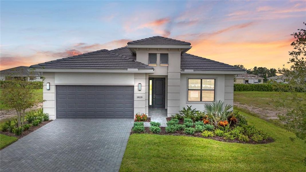 Front exterior of a new home in Cresswind Lakewood Ranch, Lakewood Ranch, FL, highlighting curb appeal (Image 24). Front exterior of a new home in Cresswind Lakewood Ranch, Lakewood Ranch, FL, highlighting curb appeal (Image 24).