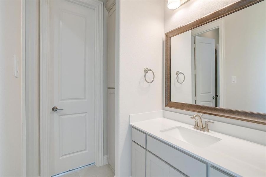 Bathroom featuring vanity and tile patterned flooring