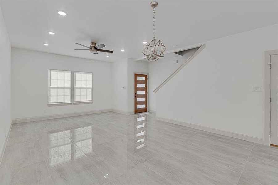 living room featuring a chandelier, recessed lighting, and a ceiling fan with marble flooring