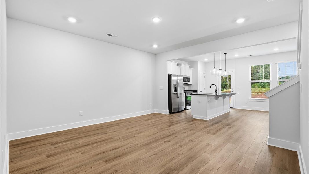 Elegant family room featuring hardwood flooring, natural light, and thoughtful architectural detail