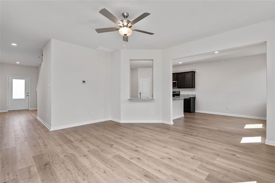 Unfurnished living room with recessed lighting, light wood-style floors, and a ceiling fan