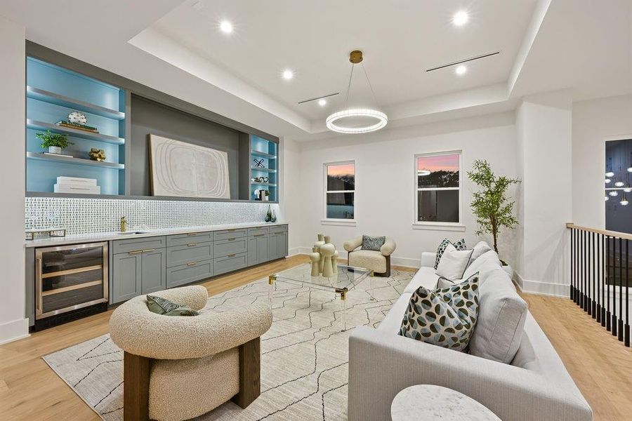 The upper level transitions into a sprawling, light-filled game room designed for both leisure and style. This multifunctional space is anchored by an impressive custom wet bar and a sophisticated color palette, offering a private escape away from the main living areas. Whether used as a media room, a sophisticated play space, or a secondary lounge, this area adds a significant layer of luxury to the home's footprint