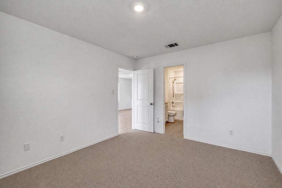 Spacious room featuring carpeting, white walls, and a recessed ceiling light Spacious room featuring carpeting, white walls, and a recessed ceiling light