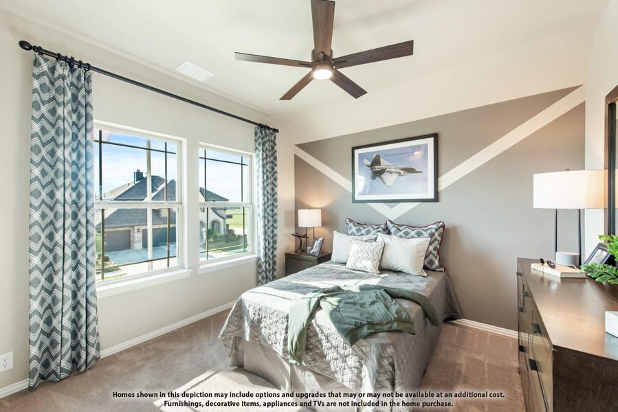 Bedroom with geometric accent wall, ceiling fan, carpet flooring, and two windows with patterned curtains Bedroom with geometric accent wall, ceiling fan, carpet flooring, and two windows with patterned curtains
