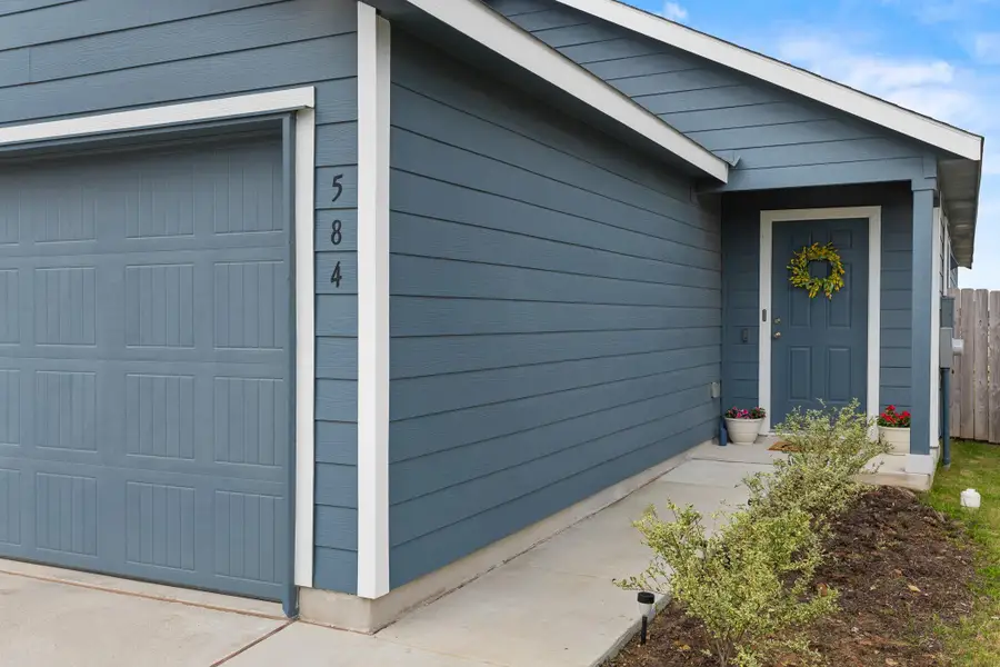 Single-story exterior featuring blue horizontal siding and white trim