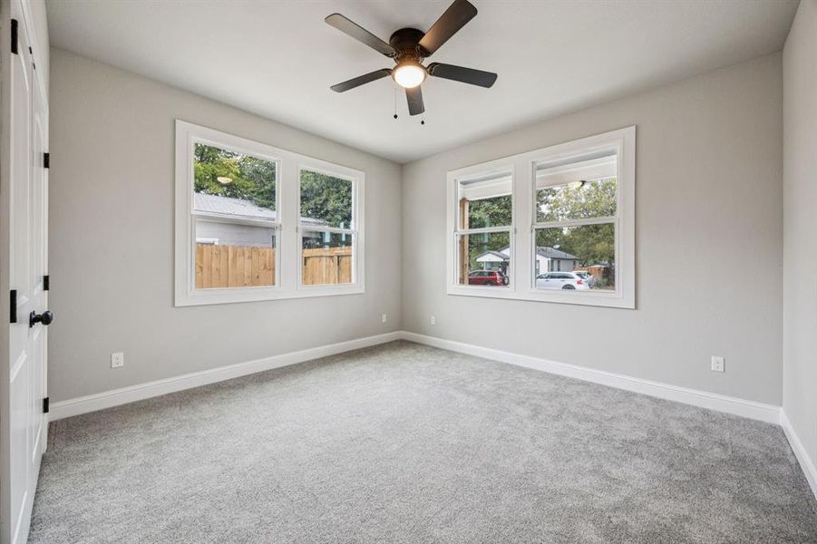 (Bedroom #2) Bedroom featuring light carpet and ceiling fan