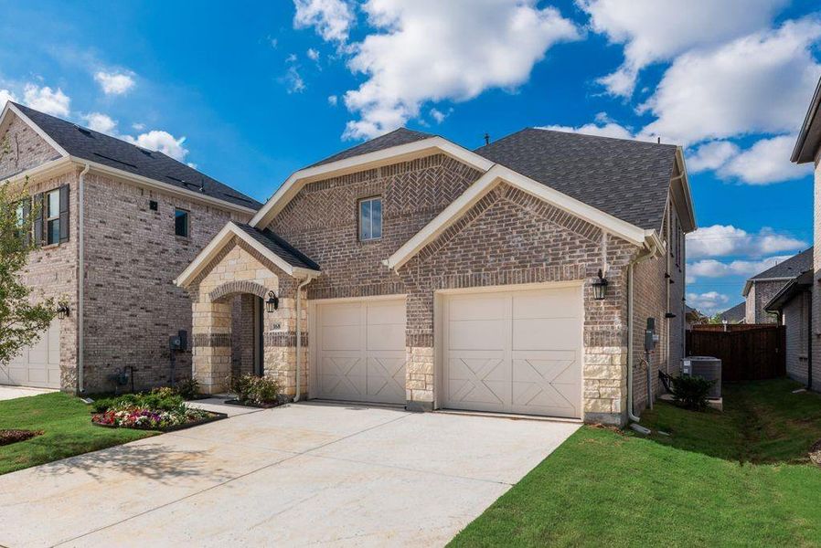 Front exterior of a new home in Spiritas Ranch, Little Elm, TX, highlighting curb appeal (Image 19). Front exterior of a new home in Spiritas Ranch, Little Elm, TX, highlighting curb appeal (Image 19).