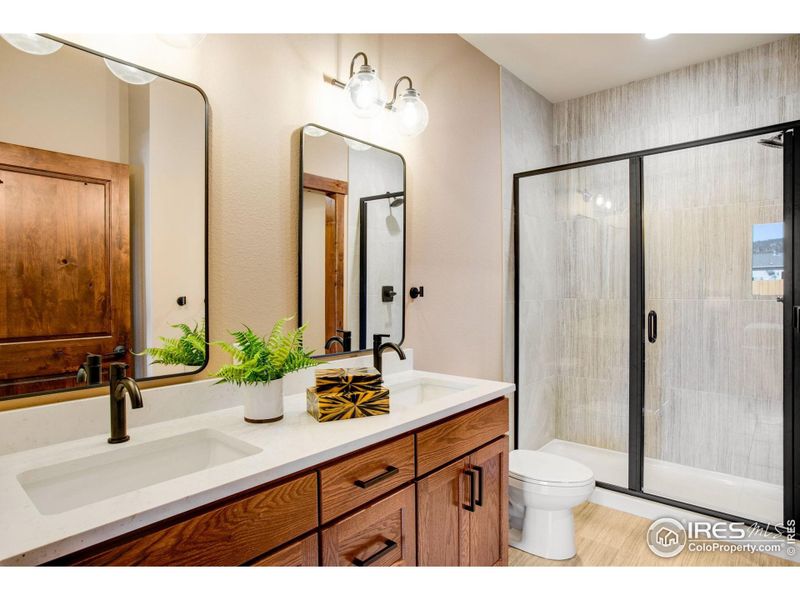 Main level primary bathroom with glass shower