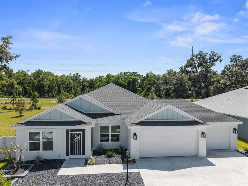 Front exterior of a new home in , The Villages, FL, highlighting curb appeal (Image 23).