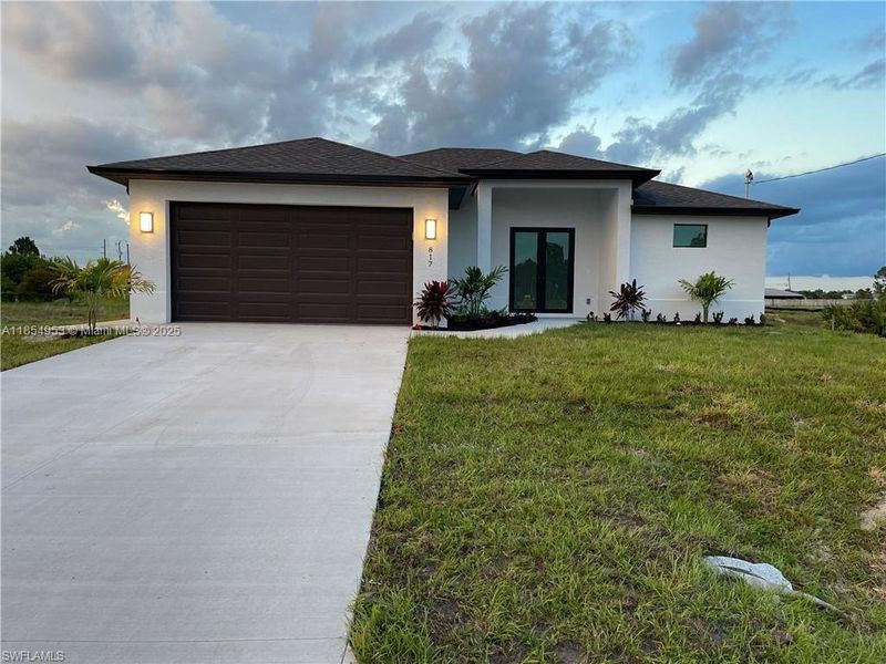 Front exterior of a new home in , Lehigh Acres, FL, highlighting curb appeal (Image 1).