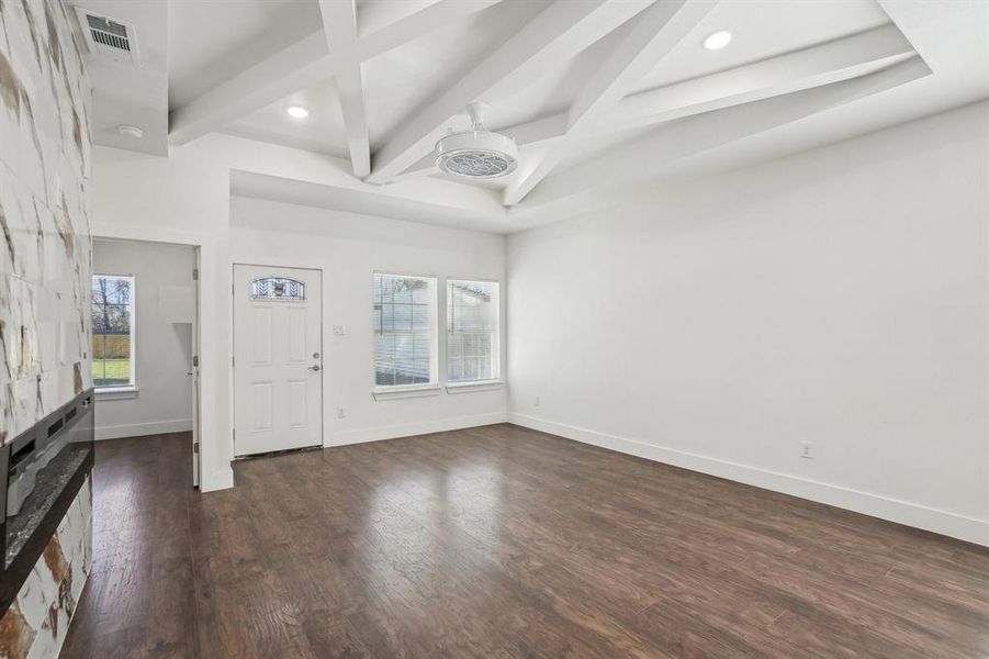 Foyer entrance featuring beam ceiling, dark hardwood / wood-style flooring, and coffered ceiling