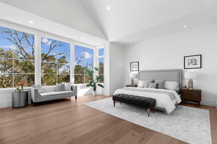 Bedroom featuring wood finished floors, multiple windows, recessed lighting, and high vaulted ceiling Bedroom featuring wood finished floors, multiple windows, recessed lighting, and high vaulted ceiling