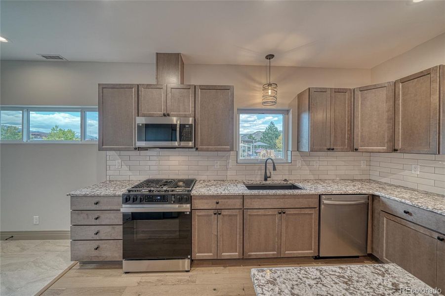 To the left of this kitchen is additional mudroom, flex space that leads to the exterior door outside.