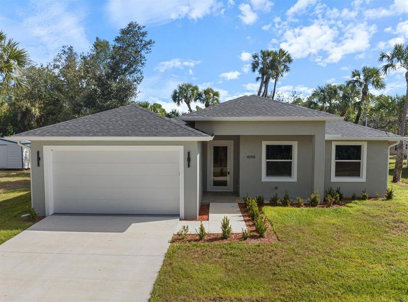 Front exterior of a new home in , North Port, FL, highlighting curb appeal (Image 1).