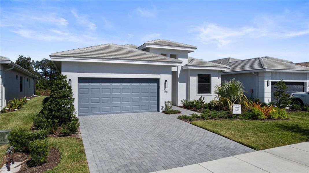 Front exterior of a new home in Cresswind Lakewood Ranch, Lakewood Ranch, FL, highlighting curb appeal (Image 18).
