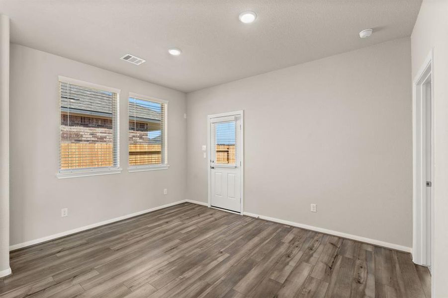 With an abundance of natural light streaming through the windows, the breakfast nook is bathed in a sunny glow, creating the perfect atmosphere to enjoy your morning coffee or a family breakfast.