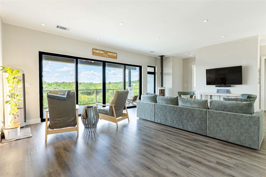 Scandinavian Jøtul fireplace creates a cozy focal point with modern flair.