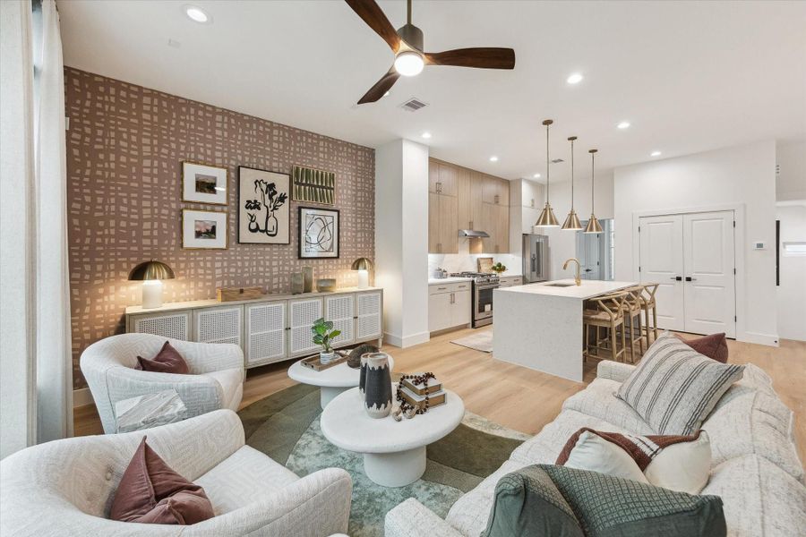 Bright living area featuring sleek ceiling fan and neutral tones Bright living area featuring sleek ceiling fan and neutral tones