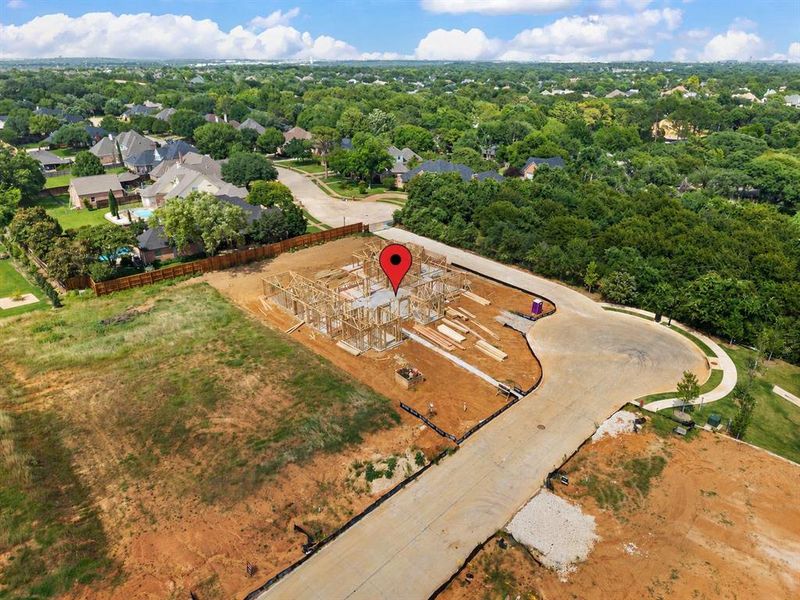 New construction framing on a spacious lot, featuring a cul-de-sac street frontage and ample surrounding land