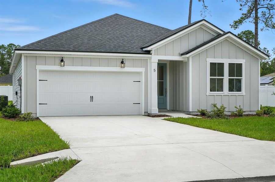 Front exterior of a new home in Palm Coast Homes, Palm Coast, FL, highlighting curb appeal (Image 22). Front exterior of a new home in Palm Coast Homes, Palm Coast, FL, highlighting curb appeal (Image 22).