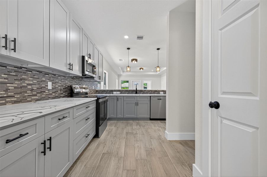 Equipped with stainless steel appliances and pendant lighting, it offers a spacious, contemporary feel with ample storage and workspace. Equipped with stainless steel appliances and pendant lighting, it offers a spacious, contemporary feel with ample storage and workspace.