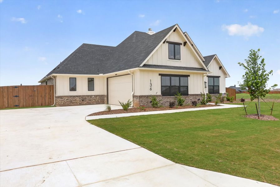 Front exterior of a new home in Coyote Crossing, Godley, TX, highlighting curb appeal (Image 23).