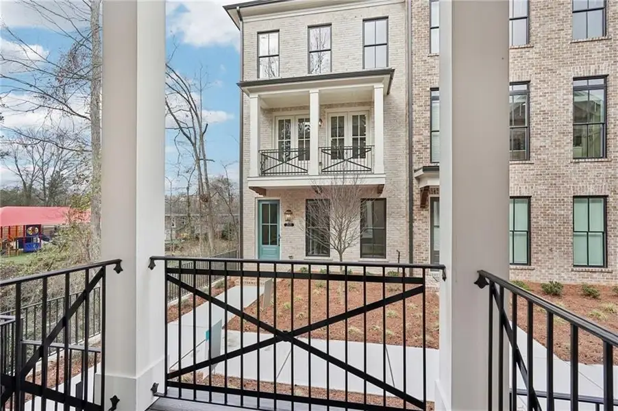 View of front balcony off kitchen space - perfect to open the door and let in fresh air and natural light.