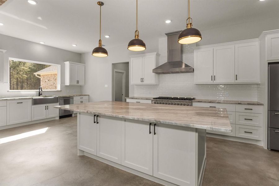The kitchen showcases an impressive oversized granite island that serves as both a stunning focal point and a functional gathering space. With ample room for seating, meal prep, and entertaining, this expansive island is perfect for hosting family and friends while staying connected to the heart of the home.