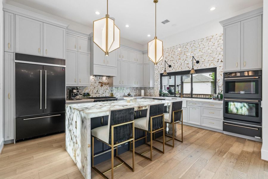 A Chefs dream kitchen from the high-end appliances to the backlit Cristallo Quartzite Countertops. A Chefs dream kitchen from the high-end appliances to the backlit Cristallo Quartzite Countertops.