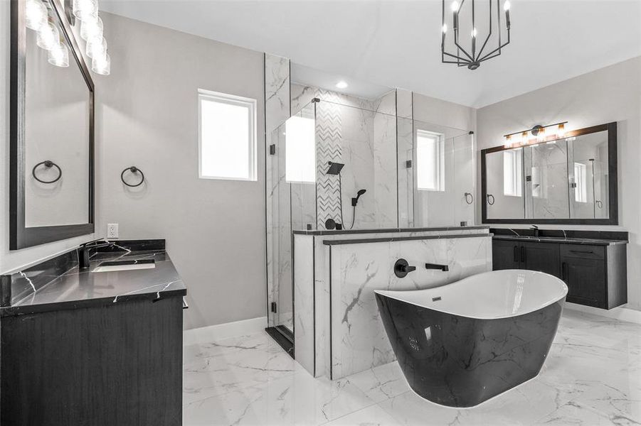 Bathroom with double sink vanity, tile patterned floors, and independent shower and bath