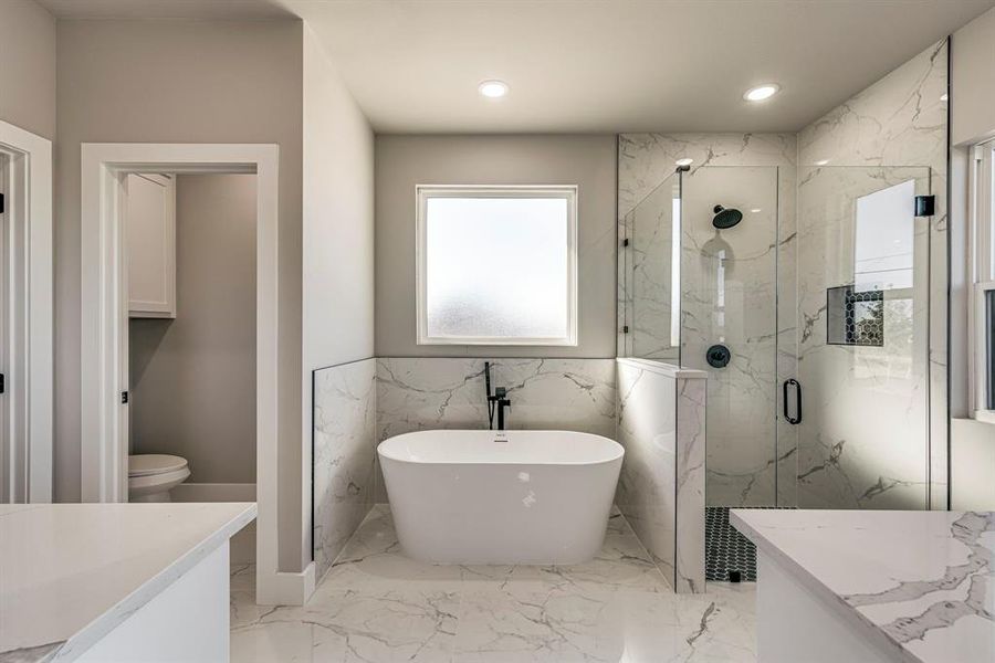 Full bath with a marble finish shower, toilet, a soaking tub, marble finish floor, and vanity