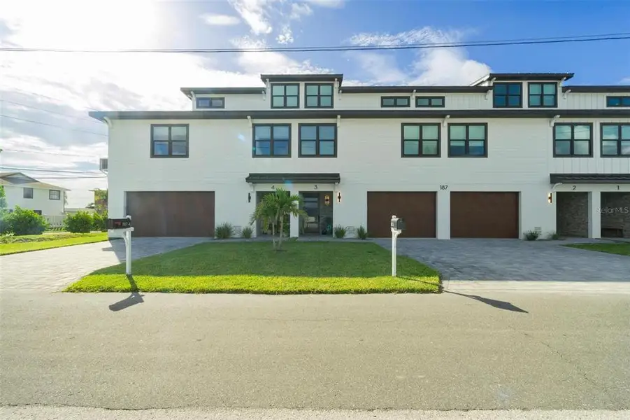 Front exterior of a new home in , Madeira Beach, FL, highlighting curb appeal (Image 25).