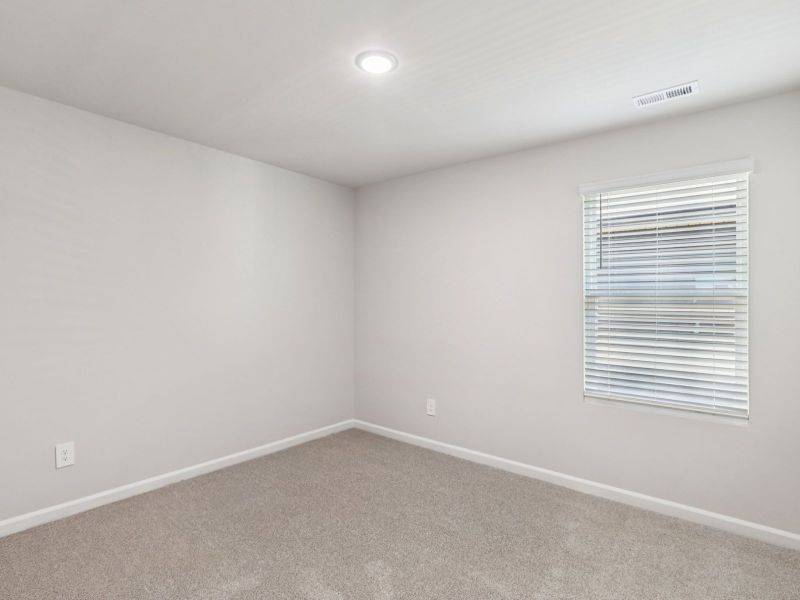 Secondary bedroom in the Paisley floorplan at a Meritage Homes community in Garner, NC.