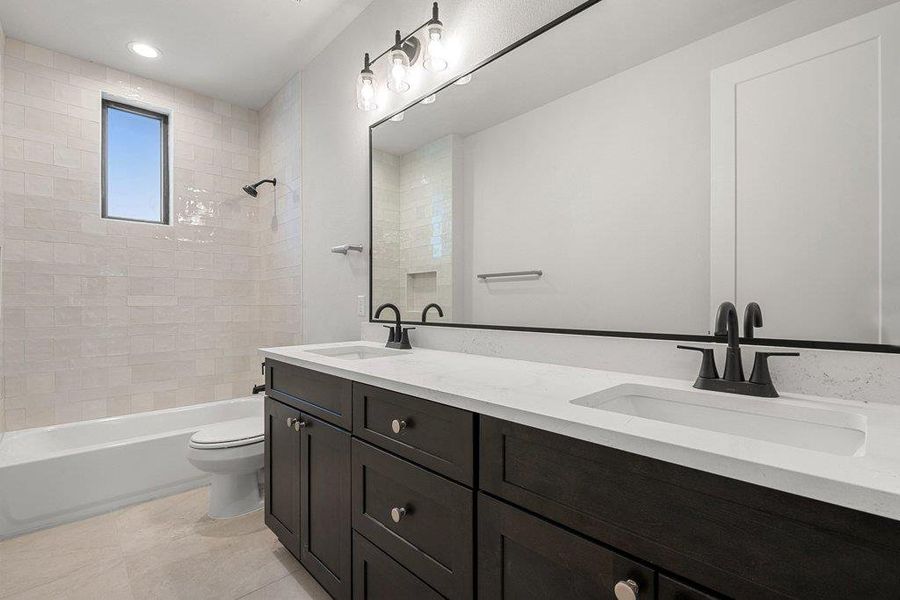 Full bathroom with double vanity, bathtub / shower combination, and recessed lighting