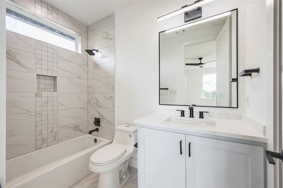 BR 3 Full bath featuring bathing tub / shower combination, vanity, and a ceiling fan BR 3 Full bath featuring bathing tub / shower combination, vanity, and a ceiling fan