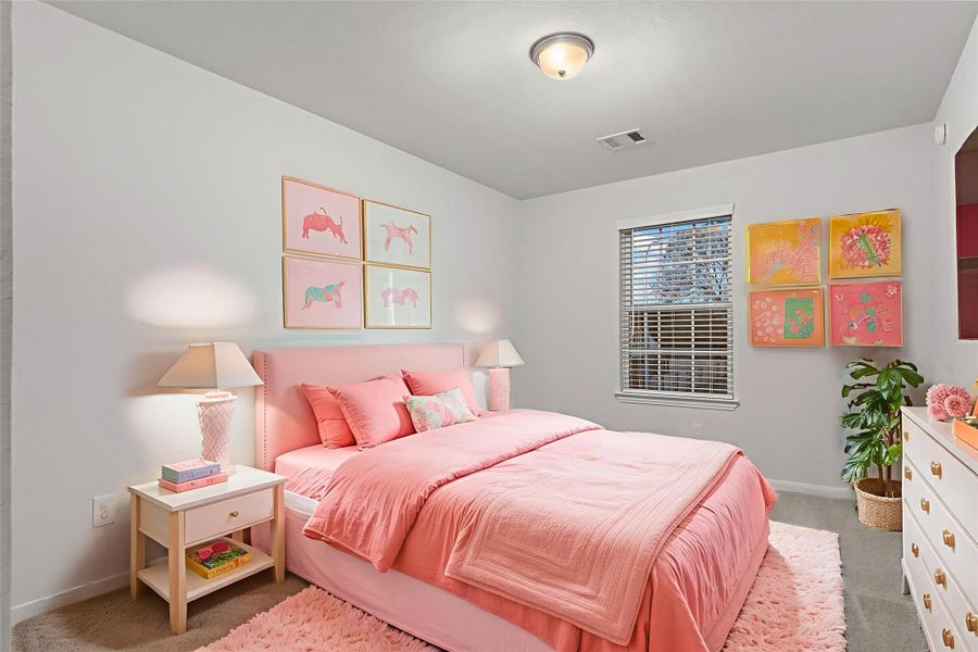 The virtually staged secondary bedroom offers a cheerful and cozy retreat, perfect for children or guests. Large windows fill the room with soft natural light, and the neutral tones make decorating effortless.