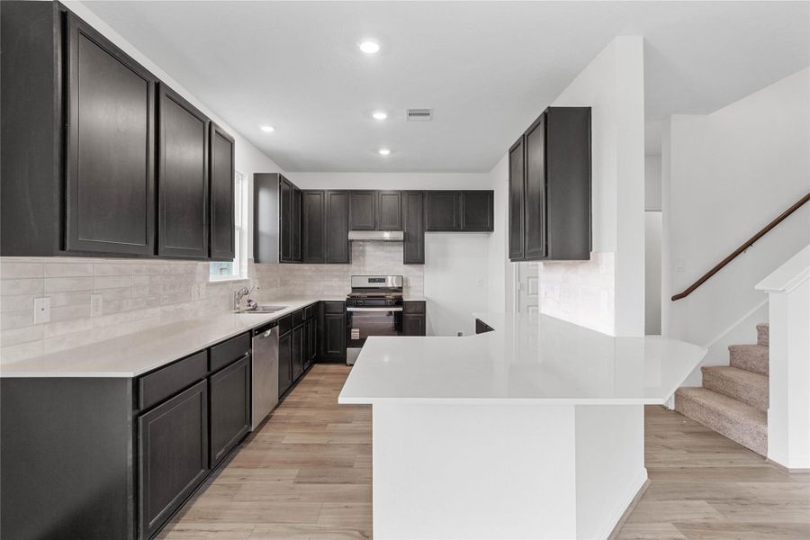 This spacious kitchen has it all—ample storage, generous counter space, and a layout that truly makes it the heart of the home. This spacious kitchen has it all—ample storage, generous counter space, and a layout that truly makes it the heart of the home.
