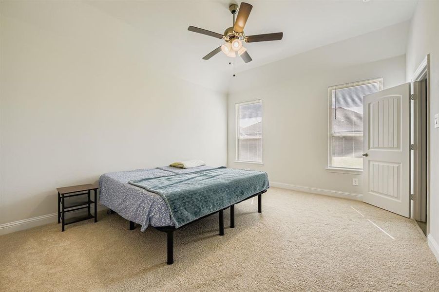 Primary bedroom with light carpet and ceiling fan Primary bedroom with light carpet and ceiling fan