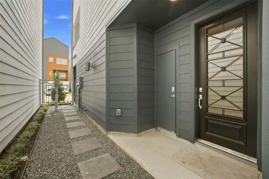 Discover a modern entrance with sleek design, featuring a convenient mailroom for easy organization.