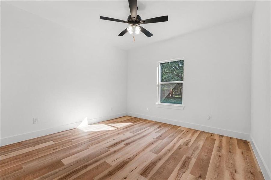 Spare room featuring light hardwood / wood-style floors and ceiling fan