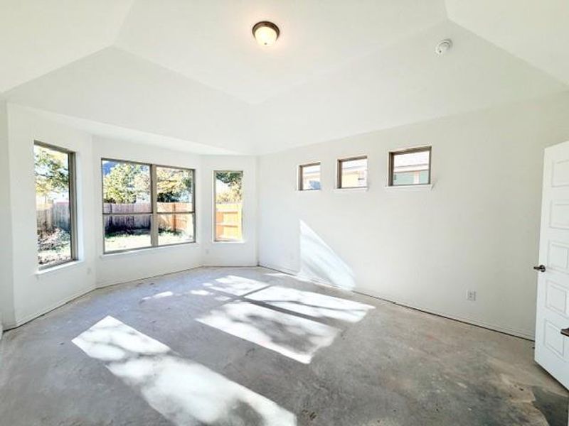 Spare room with plenty of natural light and concrete floors