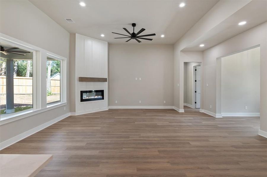 Electric Fireplace with a Modern White Surround Accent Wall and a Wooden Beam Mantel