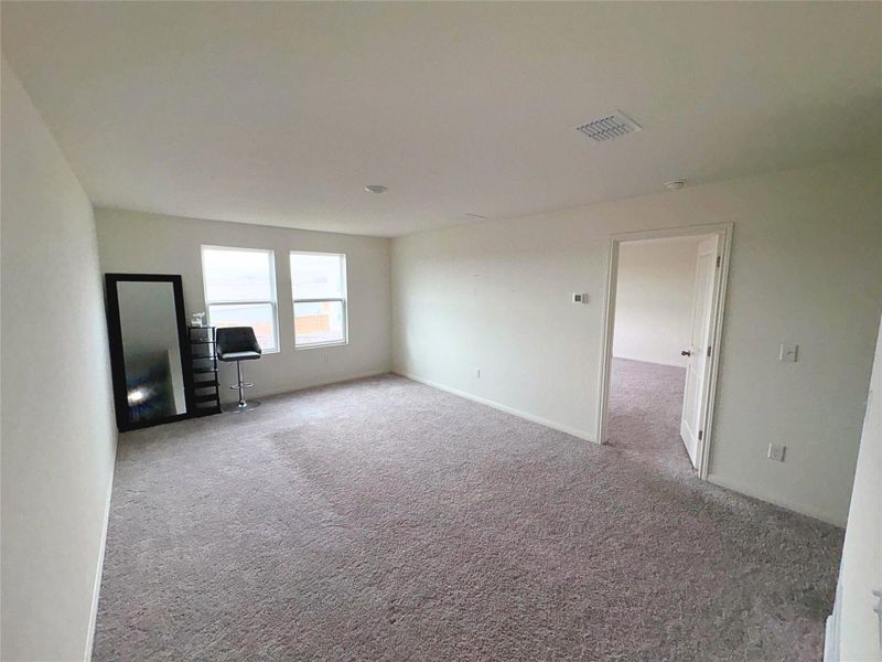 Unfurnished living room featuring carpet floors Unfurnished living room featuring carpet floors