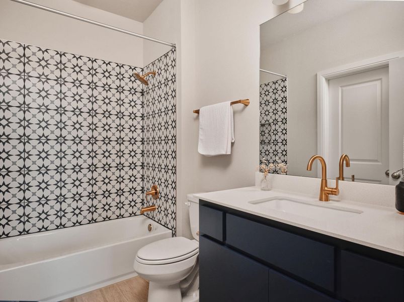 Bedroom 3's ensuite offers a quartz vanity and shower/tub combo.