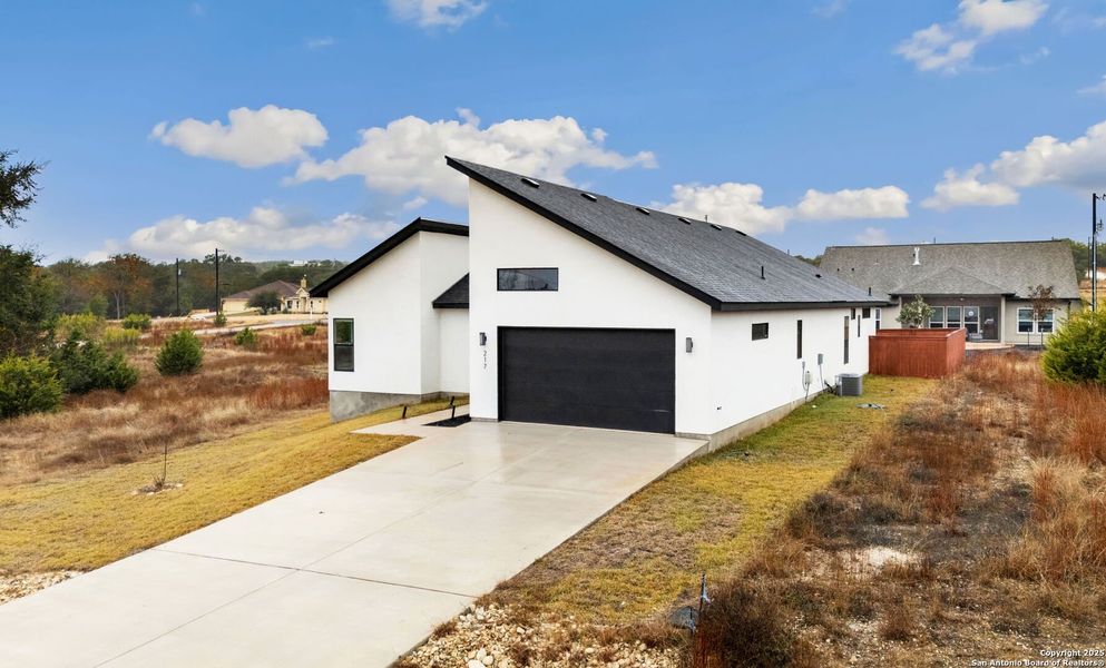 Front exterior of a new home in , Blanco, TX, highlighting curb appeal (Image 26).