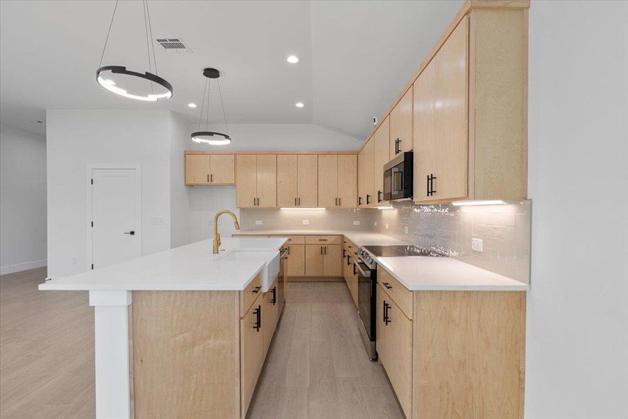 Kitchen featuring light brown cabinetry, decorative backsplash, electric range, light wood-style floors, and an island with sink Kitchen featuring light brown cabinetry, decorative backsplash, electric range, light wood-style floors, and an island with sink