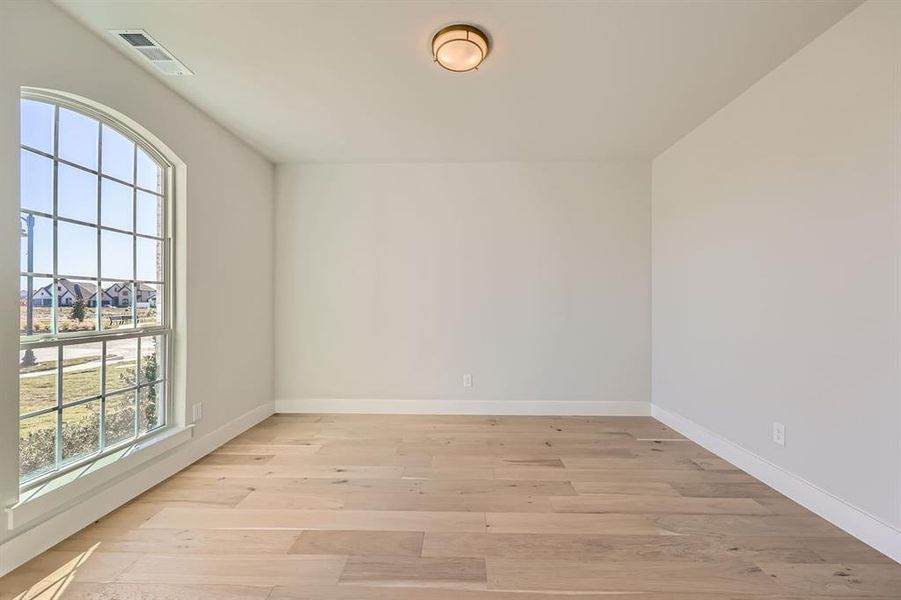 Unfurnished room with light hardwood / wood-style flooring