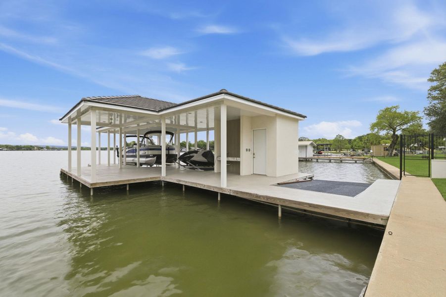 Dock area featuring boat lift and a water view